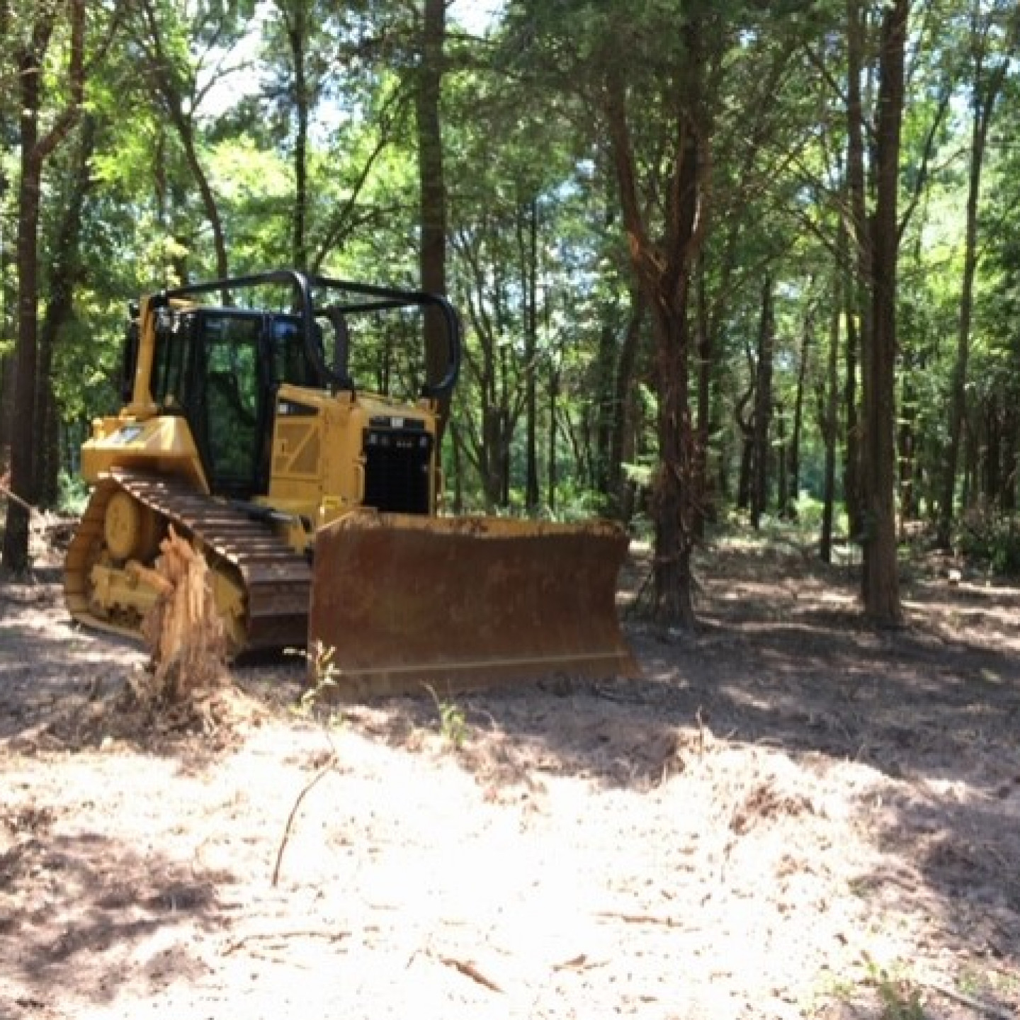 Aerial view of skid steer spreading gravel on a Charlotte job site