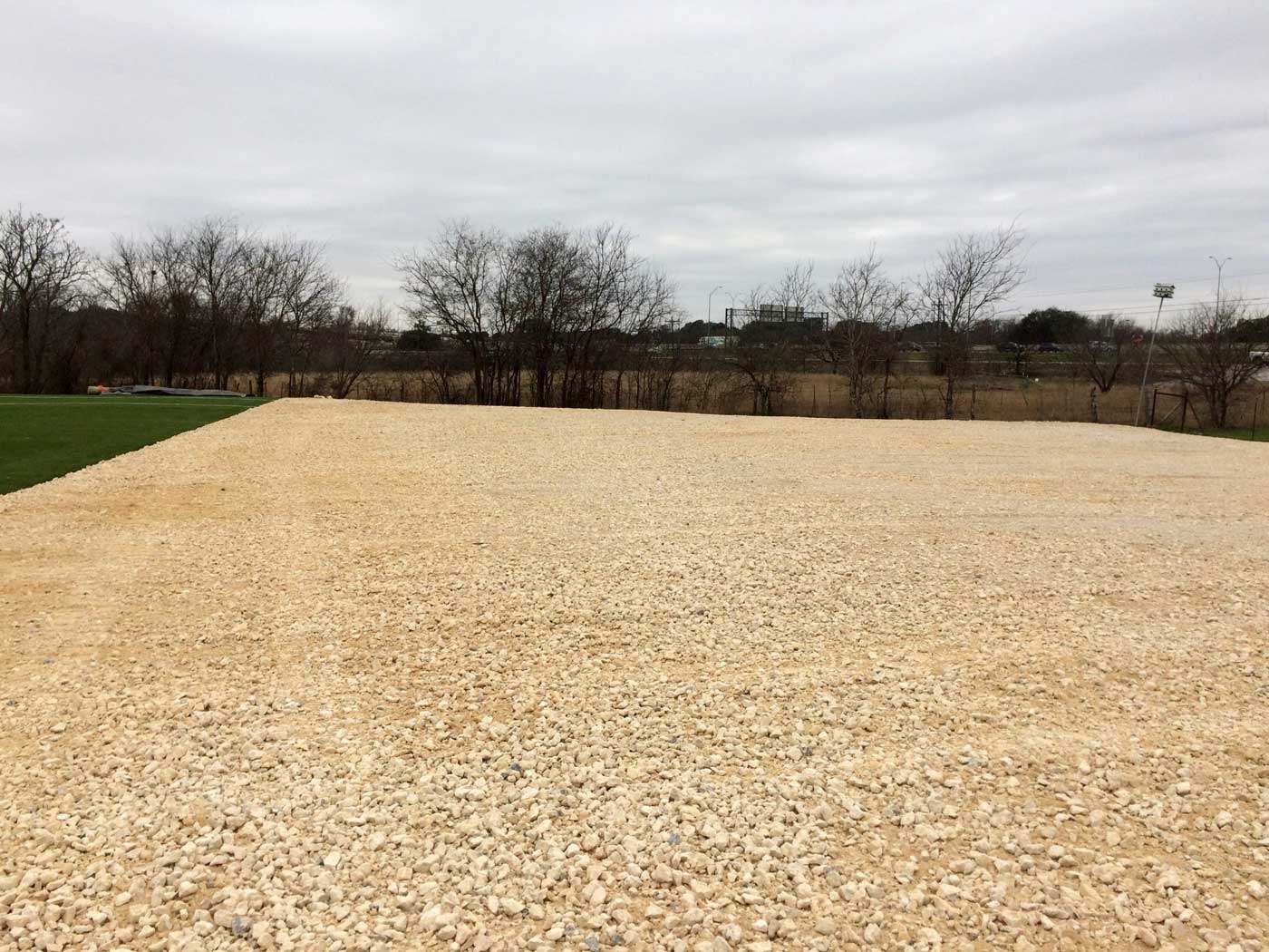 Gravel base material staged for driveway and pad work in Charlotte