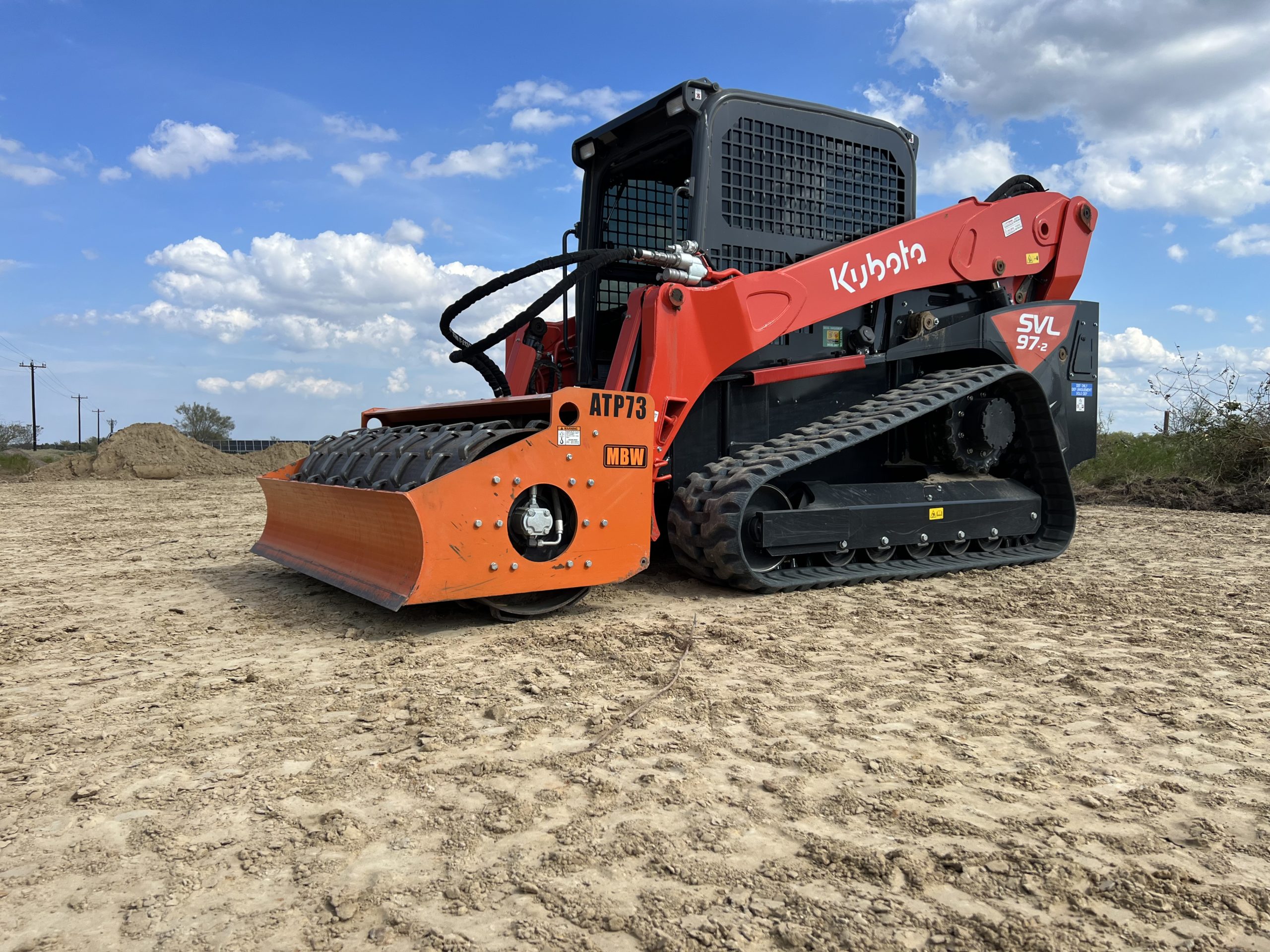 Kubota SVL97 with sheepsfoot roller compacting soil on a Charlotte site