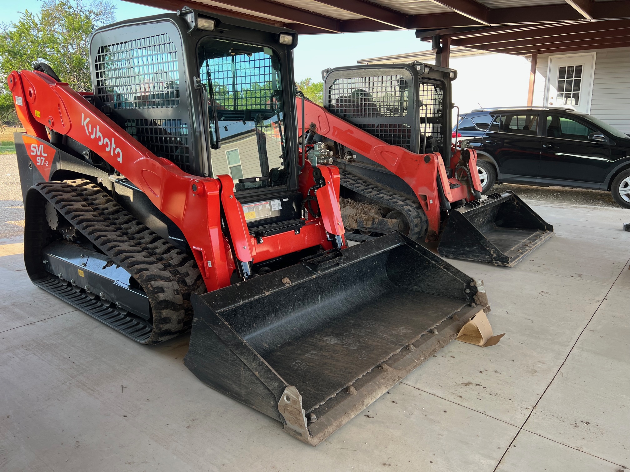 Fleet of Kubota SVL97 compact track loaders on a Charlotte job site