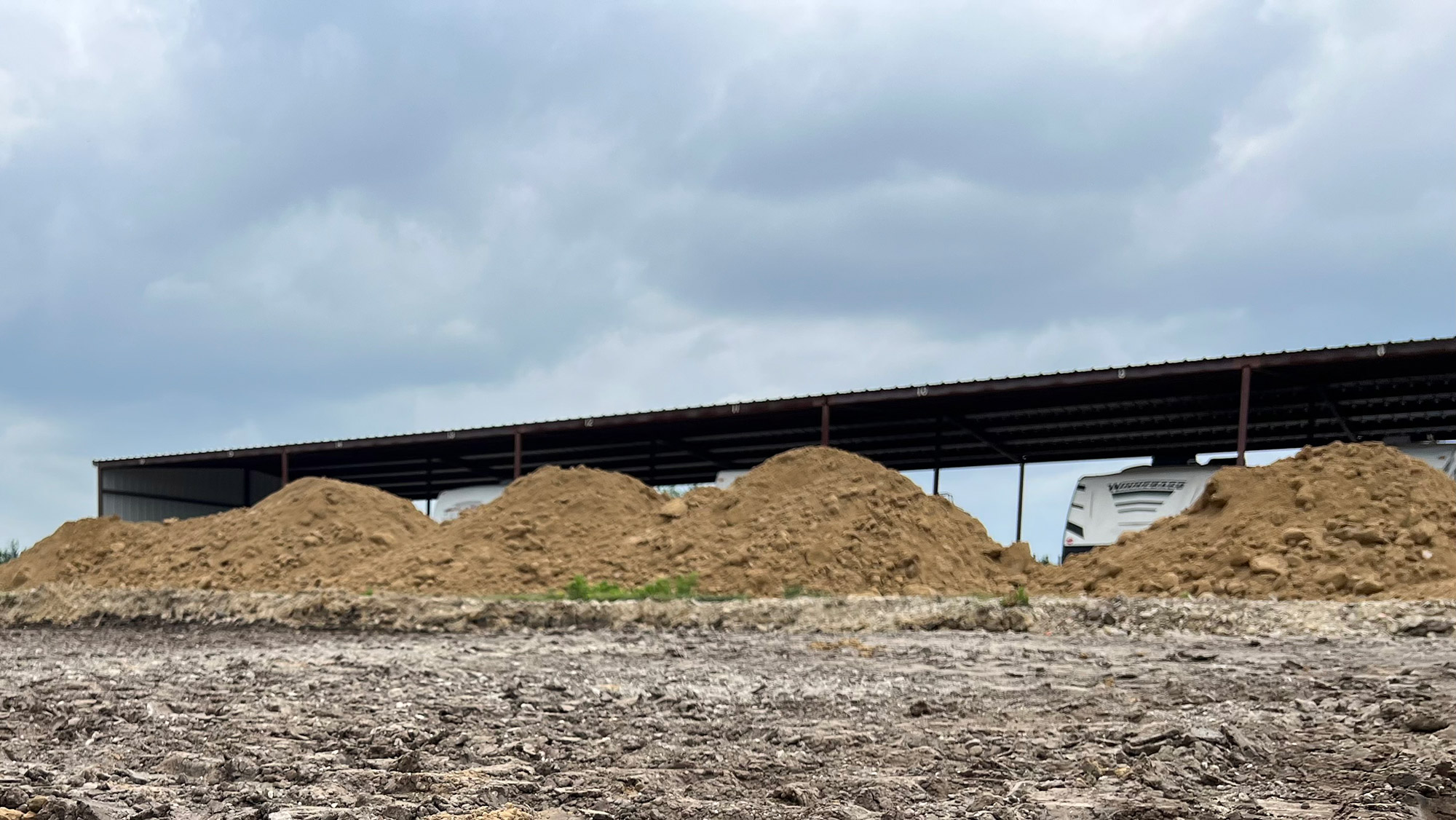Site preparation with stockpiled dirt on a Charlotte commercial project