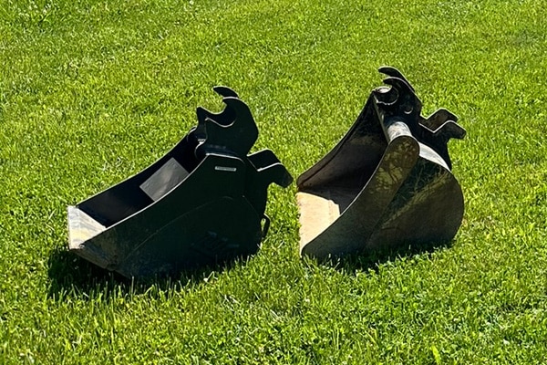Excavator buckets and attachments staged for a Charlotte excavation project